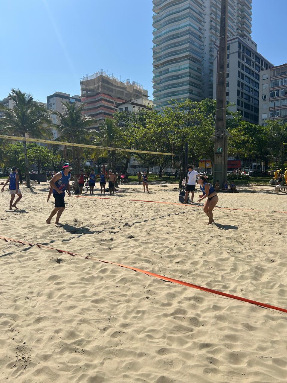 Jogadores disputando uma partida de futevôlei na praia de Santos